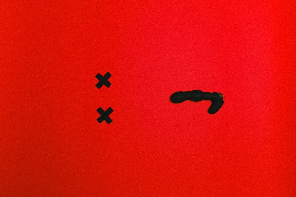 Black Sex Toy on Red Background