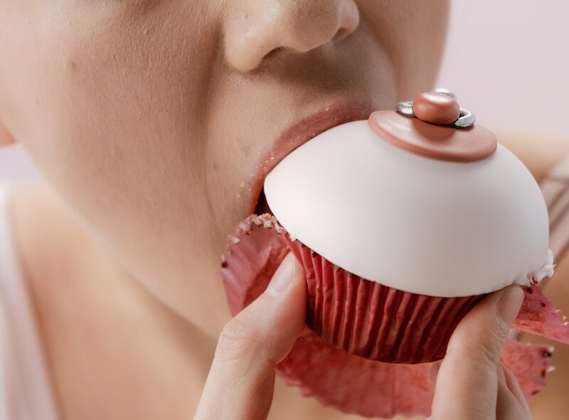 Woman Eating a Customized Cupcake